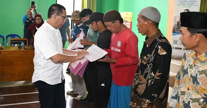 Wabup Lotim, HM Edwin Hadiwijaya Saat menyerahkan tanda kepesertaan Jamsostek.