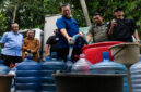 Gubernur NTB, Lalu Muhamad Iqbal saat mengisi air di galon milik warga saat melakukan kunjungan kerja ke Kabupaten Lombok Tengah, pada Senin (27/7/2026).
